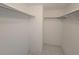 Walk-in closet with double hanging rods and tiled floor at 4915 Bay Ne St # 122, St Petersburg, FL 33703