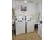 Well-lit laundry room with two modern washing machines and dryers at 4915 Bay Ne St # 122, St Petersburg, FL 33703