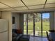 Living room with leather couch, ottoman, and sliding glass doors overlooking the courtyard at 4915 Bay Ne St # 122, St Petersburg, FL 33703