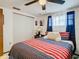 Bedroom with red and blue striped bedding and closet at 5930 Della Dr, Holiday, FL 34690