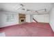 Spacious living room with fireplace and pink carpet at 6028 Elmhurst Dr, New Port Richey, FL 34653