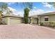 Two-car garage and house entrance with brick driveway at 6200 Bahama Shores S Dr, St Petersburg, FL 33705