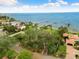 Aerial view of waterfront lot with surrounding homes and pier at 6200 Bahama Shores S Dr, St Petersburg, FL 33705