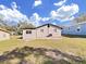 Backyard view showing home's exterior and grassy area at 715 N Disston Ave, Tarpon Springs, FL 34689