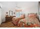 Inviting bedroom with two beds, dresser, floral bedding, and ceiling fan at 910 Oakwood Dr, Largo, FL 33770