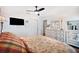Bedroom with ceiling fan, dresser and large TV at 910 Oakwood Dr, Largo, FL 33770