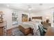 A stylish bedroom with wood furniture, soft textiles, and views of the pool area at 910 Oakwood Dr, Largo, FL 33770