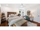 A well-lit bedroom featuring a comfortable bed, wood furniture, and stylish decor at 910 Oakwood Dr, Largo, FL 33770