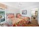 Comfortable bedroom with twin beds, floral bedding, and pool view at 910 Oakwood Dr, Largo, FL 33770