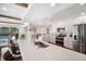 Bright kitchen with stainless steel appliances, white cabinetry, and breakfast bar at 910 Oakwood Dr, Largo, FL 33770