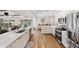 Bright kitchen with stainless steel appliances, white cabinetry, and view of the pool at 910 Oakwood Dr, Largo, FL 33770