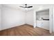 Well-lit bedroom with wood floors and convenient in-unit laundry appliances at 910 Oakwood Dr, Largo, FL 33770