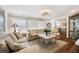 Bright living room featuring comfortable seating, decorative light fixture, and natural light at 910 Oakwood Dr, Largo, FL 33770