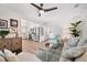 Bright living room featuring stylish decor, including wooden floors and a ceiling fan at 910 Oakwood Dr, Largo, FL 33770