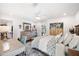 Bright main bedroom boasts white walls, patterned bedding, dresser and exterior view at 910 Oakwood Dr, Largo, FL 33770