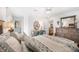 Comfortable main bedroom with desk, dresser, ceiling fan, and ensuite bathroom entrance at 910 Oakwood Dr, Largo, FL 33770