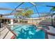 Beautiful pool and spa combo with a screened enclosure, providing a perfect setting for outdoor enjoyment and relaxation at 910 Oakwood Dr, Largo, FL 33770