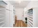 Organized walk-in closet features ample shelving, hanging rods, and hardwood floors at 910 Oakwood Dr, Largo, FL 33770