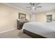 Bright bedroom with ceiling fan, dresser, and comfortable bed at 9909 Saint Joseph Ct, New Port Richey, FL 34655