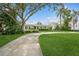 Large grassy front yard with mature trees and a long driveway at 1015 Snell Isle Ne Blvd, St Petersburg, FL 33704
