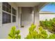 Covered porch with a view of the front door and landscaping at 12743 Rainwashed Loop, Parrish, FL 34219