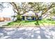 Cute blue house with yellow door, and a manicured lawn at 130 63Rd S St, St Petersburg, FL 33707