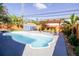 Refreshing kidney-shaped pool with a pergola and patio at 130 63Rd S St, St Petersburg, FL 33707