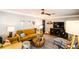 Bright living room with mustard-colored sofas and mid-century modern decor at 130 63Rd S St, St Petersburg, FL 33707