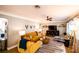 Bright and airy living room featuring a mustard-colored sofa and stylish decor at 130 63Rd S St, St Petersburg, FL 33707