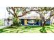 Charming ranch home with a vibrant blue exterior and yellow door at 130 63Rd S St, St Petersburg, FL 33707