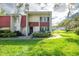 Front view of two-story condo with red tile roof and landscaping at 1827 Pine Cone Cir, Clearwater, FL 33760