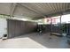 Covered parking space with storage and fenced enclosure at 1827 Pine Cone Cir, Clearwater, FL 33760
