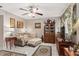 Cozy living room featuring a sofa, ottoman, and a large TV at 1827 Pine Cone Cir, Clearwater, FL 33760