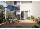 Private patio features a table, chairs, and umbrella at 1827 Pine Cone Cir, Clearwater, FL 33760