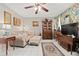 Cozy living room featuring a sofa, ottoman, and a large TV at 1827 Pine Cone Cir, Clearwater, FL 33760
