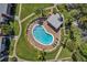 Aerial view of kidney-shaped community pool and surrounding landscaping at 1827 Pine Cone Cir, Clearwater, FL 33760