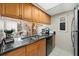 Galley kitchen with ample counter space and wood cabinets at 1827 Pine Cone Cir, Clearwater, FL 33760