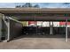 Covered parking spot with storage unit and fenced area at 1827 Pine Cone Cir, Clearwater, FL 33760