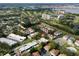 Aerial view showcasing community features, including tennis courts and a pool at 1827 Pine Cone Cir, Clearwater, FL 33760