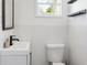 Clean bathroom with white tile, a white sink, and black fixtures at 206 W Frierson Ave, Tampa, FL 33603