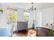 Charming bedroom with hardwood floors, bright windows, and stylish light fixture at 206 W Frierson Ave, Tampa, FL 33603