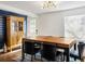 Dining room with wood table, black chairs, and a decorative cabinet at 206 W Frierson Ave, Tampa, FL 33603
