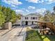 Renovated home with a spacious driveway, pergola, and landscaped yard at 206 W Frierson Ave, Tampa, FL 33603
