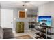 Cozy living area with a kitchenette, vintage furniture, and modern entertainment setup at 206 W Frierson Ave, Tampa, FL 33603