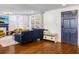 Inviting living room featuring hardwood floors, comfortable seating, and a stylish blue accent door at 206 W Frierson Ave, Tampa, FL 33603