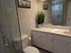Bathroom with double sinks, large mirror, and walk-in shower at 212 Poinciana Ln, Largo, FL 33770