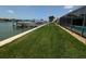 Well-maintained backyard leading to the water and dock, perfect for outdoor activities and enjoying water access at 212 Poinciana Ln, Largo, FL 33770