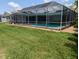 Enjoy the outdoors in this private backyard featuring a screened-in pool and well-maintained green space at 212 Poinciana Ln, Largo, FL 33770