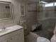 Bathroom with walk-in shower, built-in bench, and updated vanity at 212 Poinciana Ln, Largo, FL 33770