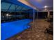 Inviting pool area with waterfront views at night and ambient lighting, ideal for evening relaxation at 212 Poinciana Ln, Largo, FL 33770